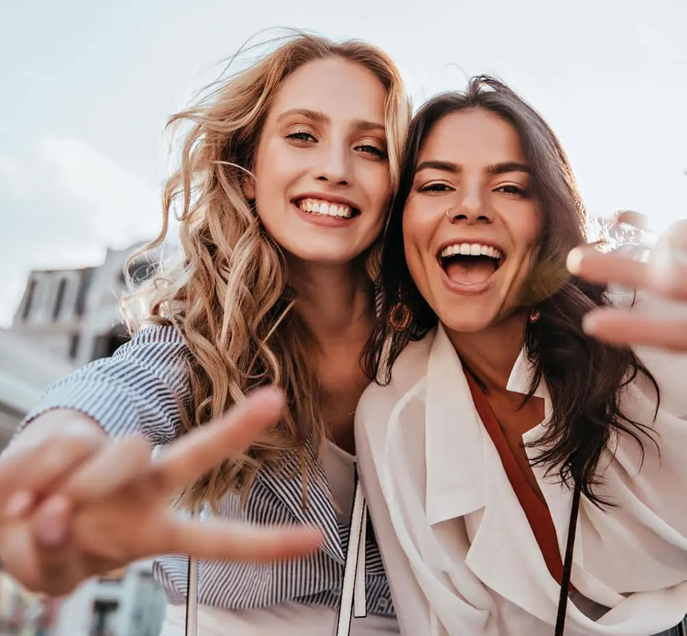 Friends laughing and showing confident smiles