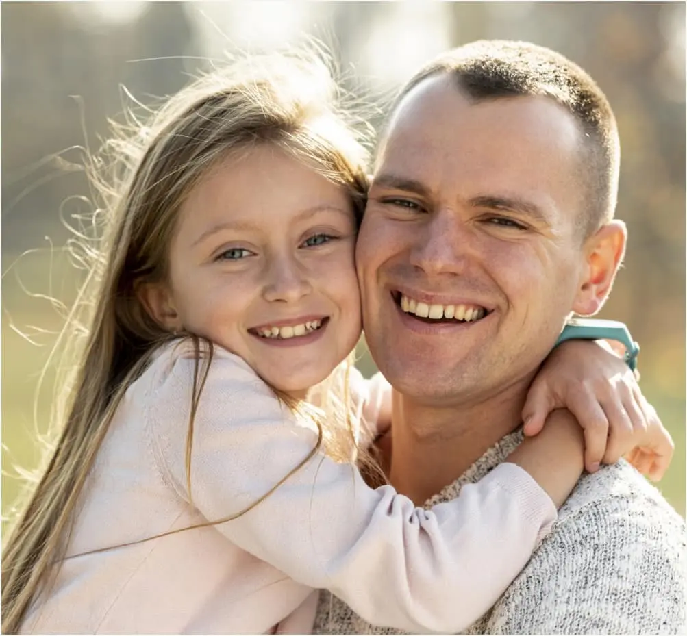 Father and daughter smiling together after family dental care at Sierra Springs Dental in Airdrie