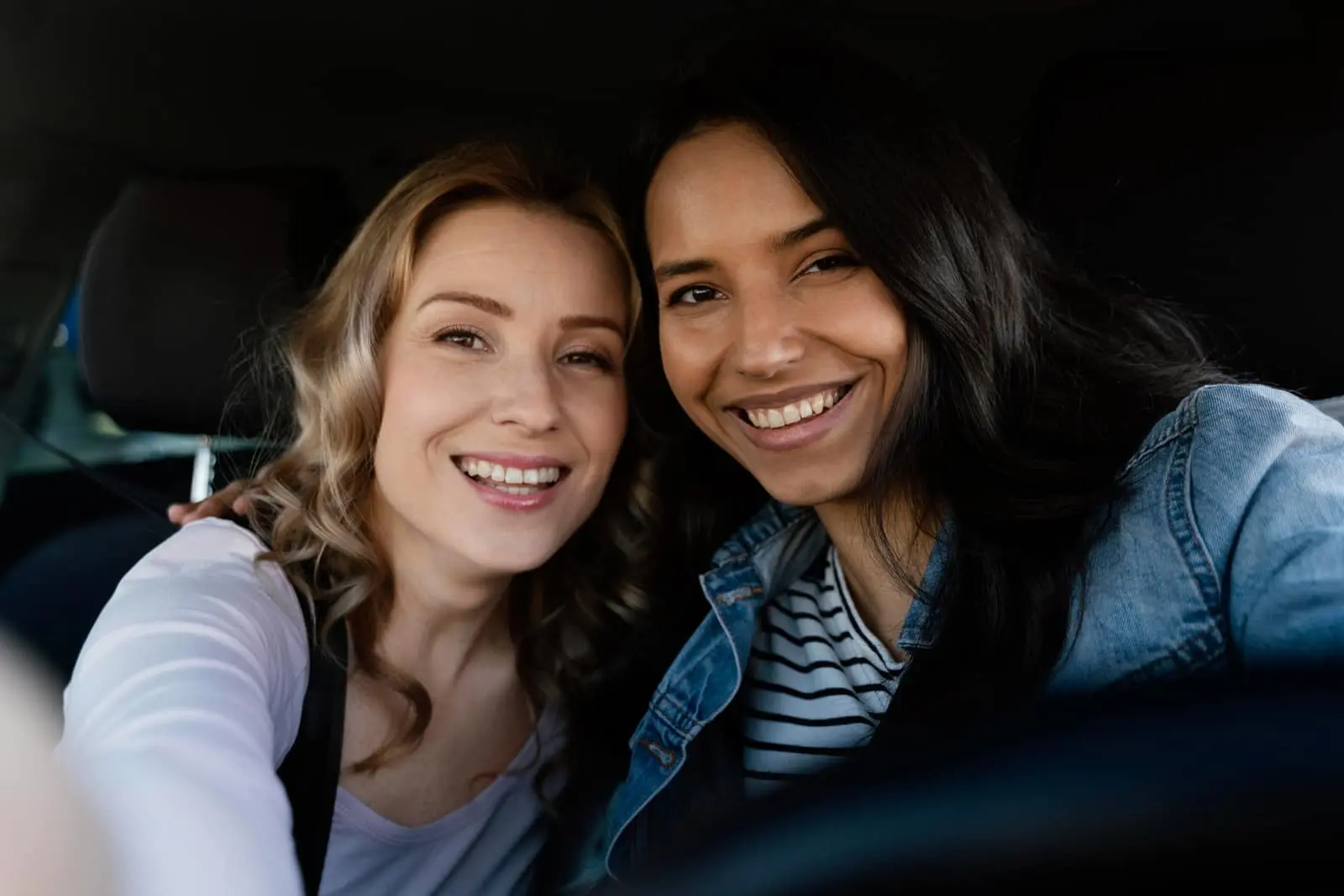 Two women smiling confidently after cosmetic dentistry at Sierra Springs Dental in Airdrie
